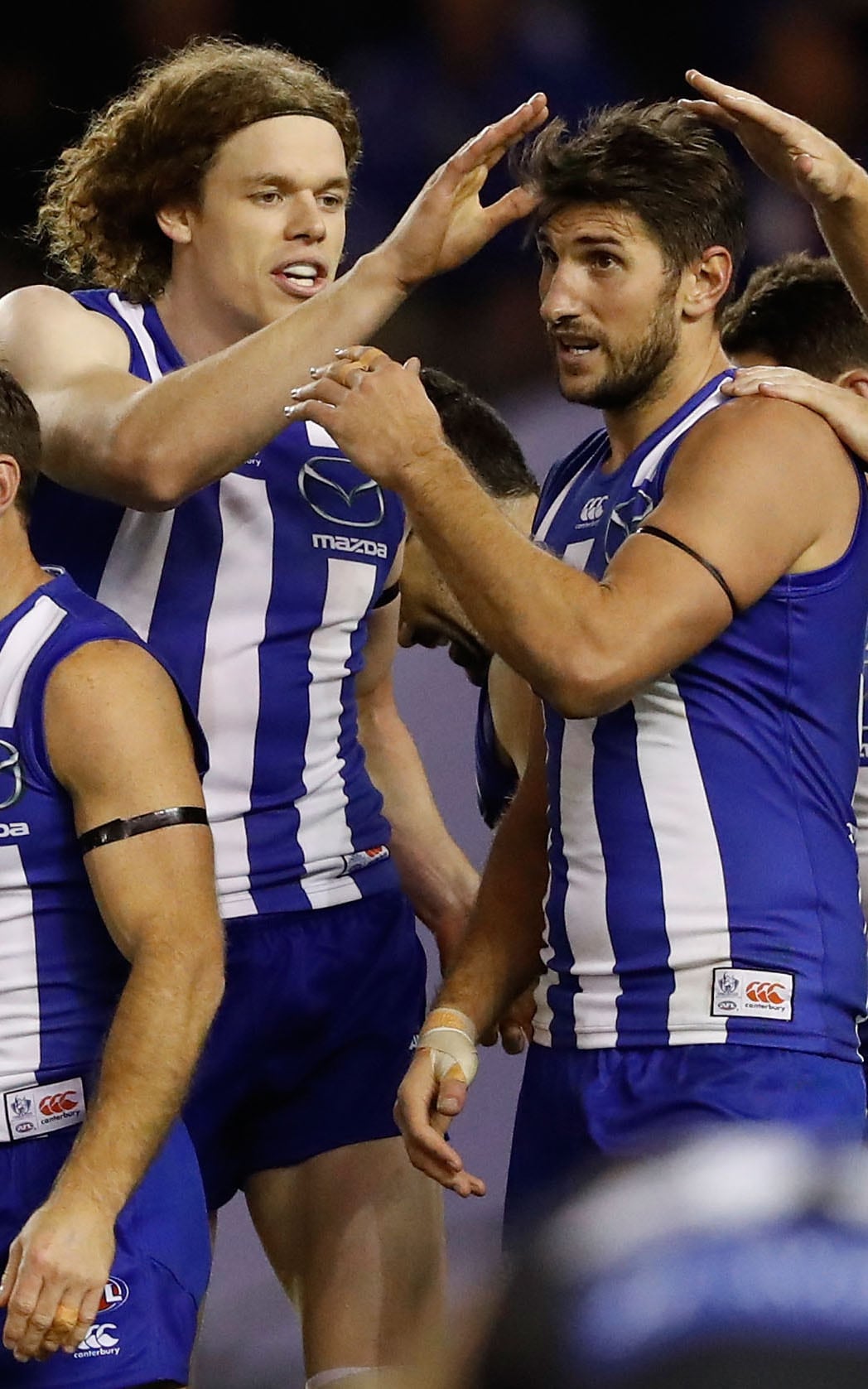 AFL 2016 Rd 09 - North Melbourne v Carlton MELBOURNE, AUSTRALIA - MAY 21: Jarrad Waite of the Kangaroos is congratulated by teammates Ben Brown (left) and Drew Petrie of the Kangaroos during the 2016 AFL Round 09 match between the North Melbourne Kangaroos and the Carlton Blues at Etihad Stadium on May 21, 2016 in Melbourne, Australia. (Photo by Adam Trafford/AFL Media)